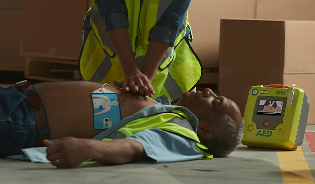 Worker performing CPR with AED